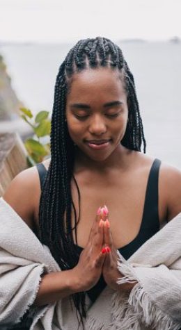 Woman meditating with hands together, calm and relaxed